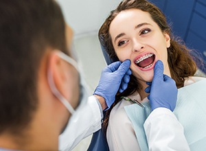 Young woman attending orthodontic checkup with dental team
