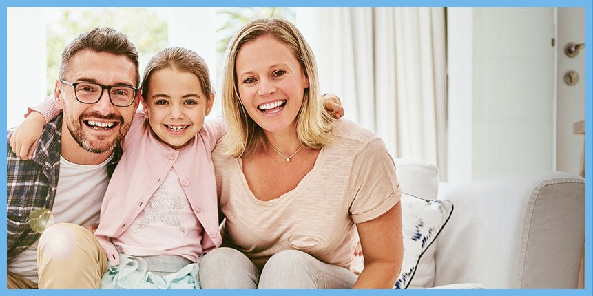 Smiling mother father and child on couch