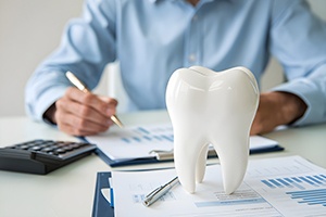 Person budgeting for the cost of dental care