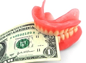 Dollar bill between upper and lower dentures