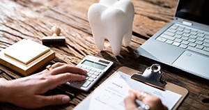 Using calculator and invoice to calculate cost of dental care