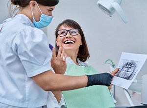 Happy patient talking with dental team member