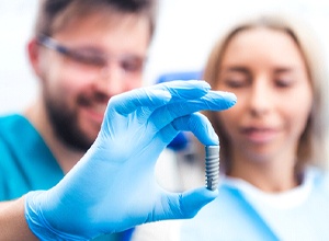 Dentist and patient discussing candidacy for implant dentures