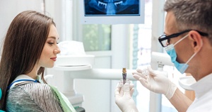 Dentist explaining what happens during dental implant surgery
