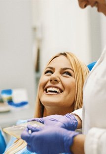 patient smiling while visiting dentist 