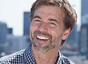 Older man smiling in during dental treatment