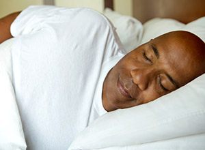 Man sleeping soundly in bed