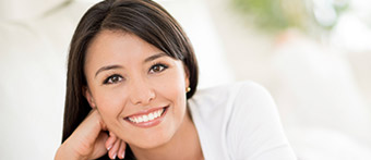 woman in white suit smiling