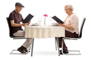 Senior couple looking at food menu in restaurant