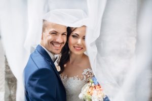 Bride and groom with radiant smiles after teeth whitening in Meriden