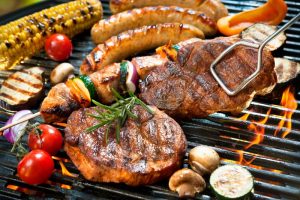 Delicious summer foods cooking on grill