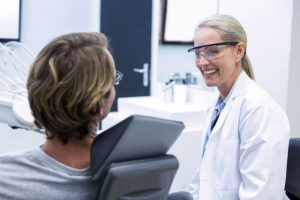 Dentist and patient talking about treatment options