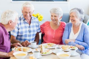 Group of senior friends enjoying a meal together