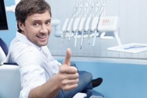 Happy man at appointment to maximize dental insurance benefits