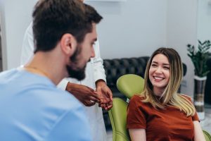 Happy patient conversing with dental team