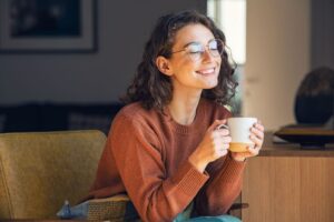 Smiling woman holding a cup of coffee