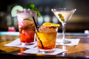 Three cocktails arranged on countertop