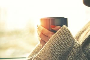 Woman holding hot cup of coffee